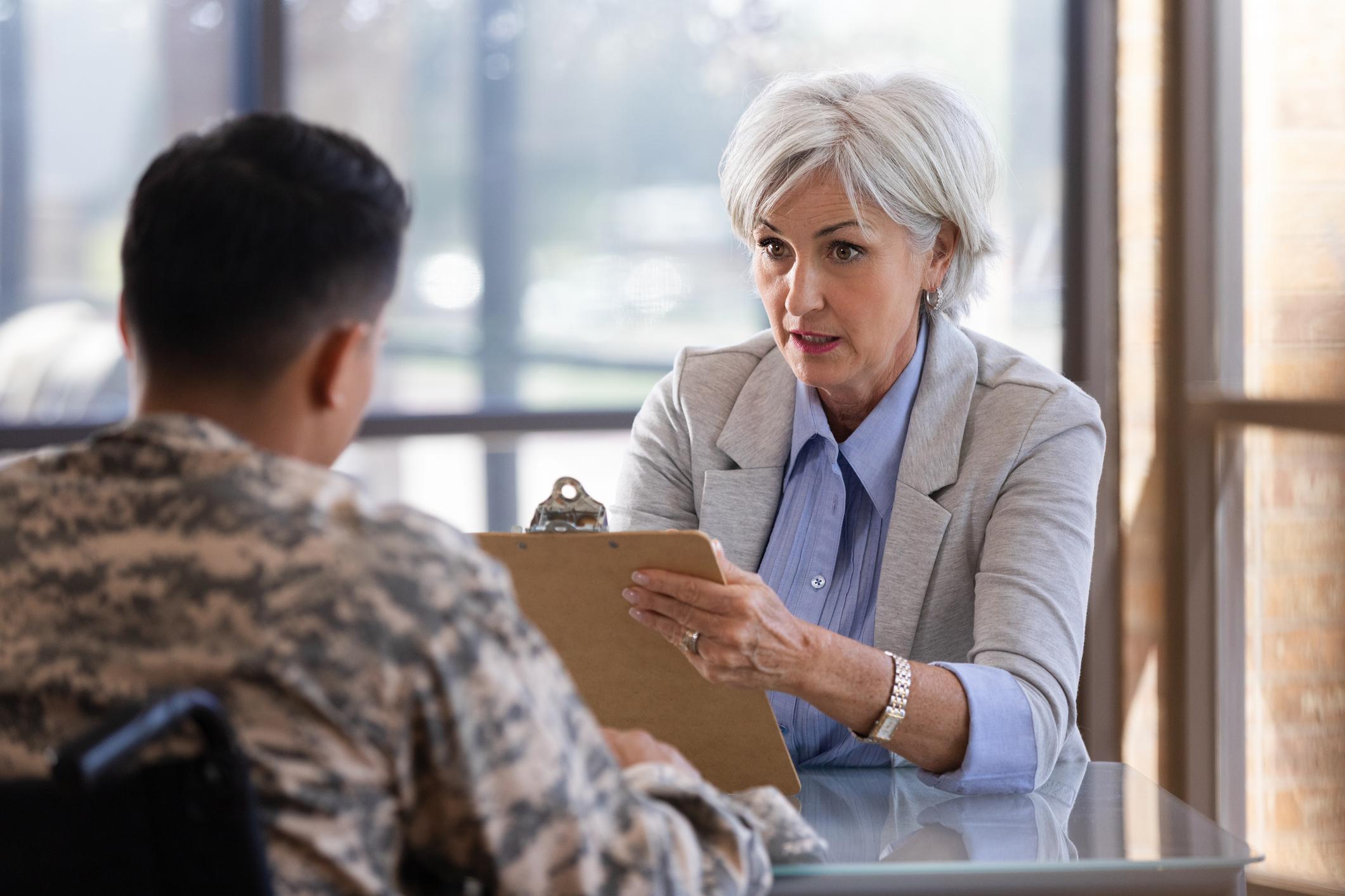 Senior woman doctor consulting with a patient about prostate cancer treatment options.