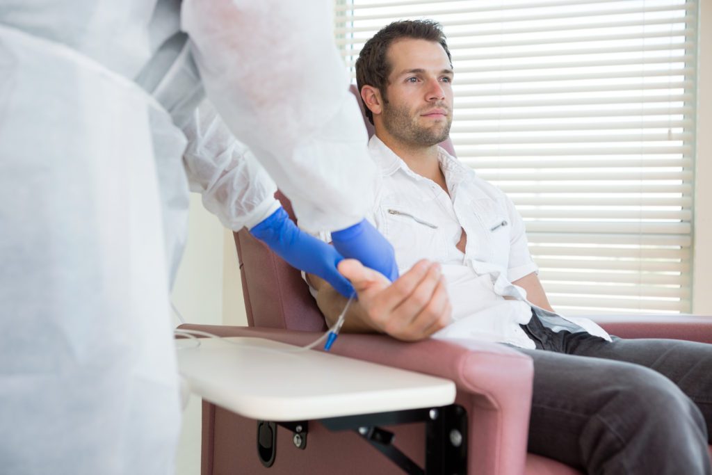 Young,Male,Patient,Receiving,Intravenous,Treatment,In,Chemo,Room